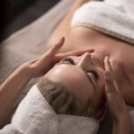 young-woman-massaging-her-client-s-face
