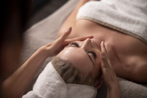 young-woman-massaging-her-client-s-face